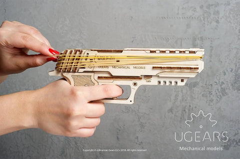 Wooden Wolf 01 Handgun 3D Puzzle rubber band gun model in hands, side view with bands loaded