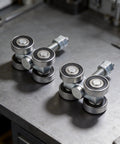 Heavy Duty 4 Wheel Trolley Assembly Rollers With Rust Resistant Galvanized Body High Carbon Steel Core For No Sweat Cart Repairs And Reliable Gear Hauling On Any Project Or Daily Grind on metal surface with nuts and bolts.