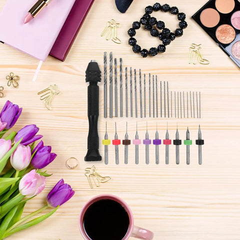 Pin Vise Hand Drill Set With Miniature Engraving Bits And PCB Drill Bits For Jewelry Making Resin And Polymer Clay Craft Manual Precision Tool Kit 36 Pieces DIY Hobbyist Favorite displayed on a wooden table with flowers and coffee.