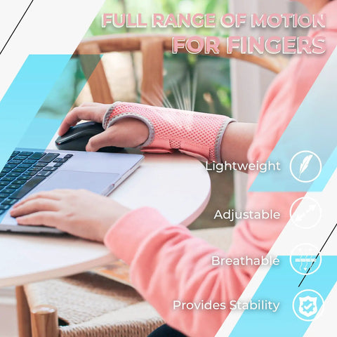 Person wearing pink breathable carpal tunnel wrist brace with 2 adjustable straps, using laptop, right hand.