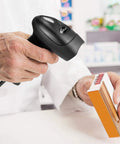 Handheld USB 1D Barcode Scanner With Stand Wired CCD Barcode Reader scanning product at store counter