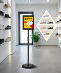 Two Pack Adjustable Floor Sign Stand 8.5 By 11 Inch Poster Holder with 360 Degree Rotating Frame in a shoe store displaying a sale ad