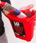 Person holding Grab And Go 16 Oz Paint Cup With Magnetic Brush Holder For Trim Work And Touch Ups Mess Free Quick Cleanup