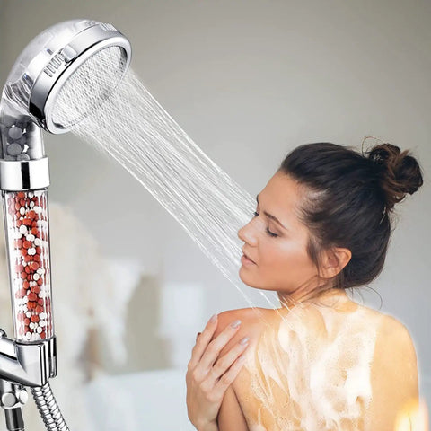 Woman using Kickin High Pressure Handheld Shower Head With 59 Inch Hose And Bracket, Vortex Turbo Spray, Ionic Filter