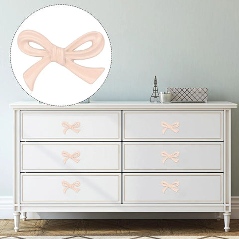 Dresser with Six Pack Bow Shaped Cabinet Knobs With Screws In Light Pink for vintage-style decor, easy install hardware