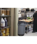Heavy Duty 44 Gallon Gray Trash Can With Dome Top And Snap Lock Industrial Workhorse Waste Bin Built Rock Solid Stackable Commercial Storage Container Made In Usa in a kitchen setting with food preparation.