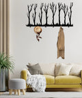 Rustic Winter Tree Grove Metal Wall Hooks above a sofa, with a hat and coat hanging, minimalistic branch design for entryway decor.