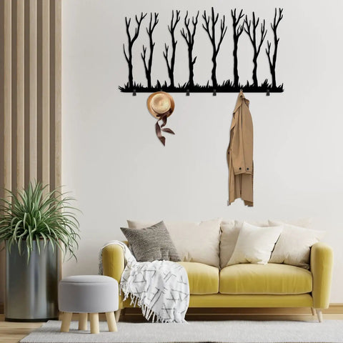 Rustic Winter Tree Grove Metal Wall Hooks above a sofa, with a hat and coat hanging, minimalistic branch design for entryway decor.