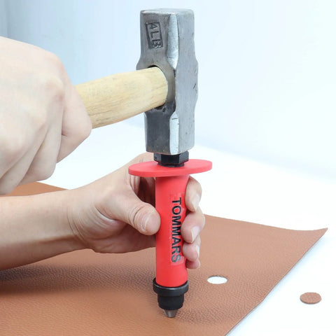 Hollow Punch Kit With Pinpoint Punch Shaft And Gasket Cutter Set, used for precise cutting in leather, shown in action with hammer.