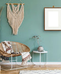 Stylish living area with wicker chair, wall art, and Bronze Stainless Steel Cubicle Wall Hooks For Fabric Panels Holds 40 Lbs