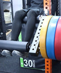 Seated Leg Extension And Curl Machine For Home Gym With Plate Loaded System featuring color-coded weight plates in use