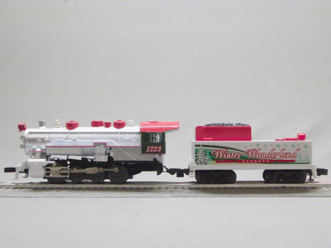 Winter Wonderland LionChief Steam Locomotive Engine for O Gauge, Remote Control Included, side view on track.