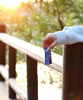 Hand holding blue flashlight from 20-Pack Aluminum 6-LED Flashlights Set With Lanyard, AAA Batteries Included And Pre-Installed outdoors