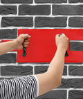 Person using Sturdy PU Concrete Stamp Mats 19.29 By 7.87 Inch Realistic Stone Texture Molds on wall for seamless DIY imprinting.
