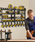 Heavy Duty Power Tool Organizer Wall Mount For Garage With 8 Cordless Drill Holders, metal shelf, tools displayed, person working.