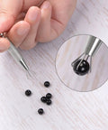 No Nonsense Stainless Steel Four Claw Pick Up Tool For Jewelry Crafting and Fine Gem Setting With Easy Grip Knurled Handle and Dependable Diamond Holder Pliers holding black bead.