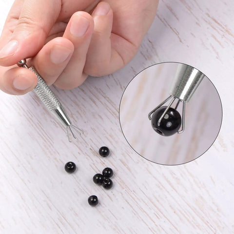 No Nonsense Stainless Steel Four Claw Pick Up Tool For Jewelry Crafting and Fine Gem Setting With Easy Grip Knurled Handle and Dependable Diamond Holder Pliers holding black bead.