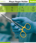 TC Mayo Hegar Needle Holder And Suture Driver With Tungsten Carbide Inserts And Gold Ring Handles For A Rock Solid Non Slip Grip Premium Grade Seven Inch Medical Instrument held by gloved hand.