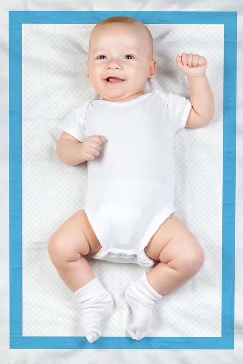 Smiling baby lying on Super Absorbent Disposable Underpads And Incontinence Bed Pads 23 X 36 Inch with blue border.
