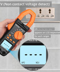 True RMS Clamp Meter 800A AC DC With 6000 Count Multimeter showing NCV detection near an electrical socket, focus on display screen