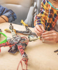 Person assembling drone using Beefy Hardened Steel RC Pinion Gear Set 18T 19T 20T 21T 22T For 3.175 mm Shaft, 48 Pitch, 9mm Height