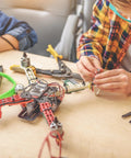 Person assembling drone with tools and 48P Steel Pinion Gear Set For RC Cars 14T 15T 16T 17T 18T On 3.175mm Shafts