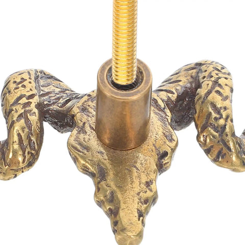 Close-up of Brass Goat Head Cabinet Knob Pull Handle Vintage Animal Drawer Knob For Kitchen Cabinets And Dresser Rustic Metal Cupboard Hardware Durable Goat Head Design With Premium Craftsmanship Ideal Rustic Farmhouse Decor showing textured brass goat head with screw attachment.