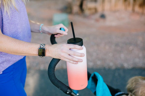 Person holding a bottle with Insulated Leak Proof Straw Lid For Summit And Hydro Flask Wide Mouth Bottles On The Go Keeps Drinks Cold Longer Splash Proof Cap Midnight Black Road Trip Ready
