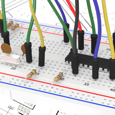 Solderless Breadboard Jumper Wires Kit For Electronics Prototyping With 400 And 830 Tie Point Boards, 14 Values, 24AWG U-Shape Male To Male Wires, 126 Pieces Ribbon Cables, ABS Plastic Panel, Tin Plated Contacts used on a white breadboard.