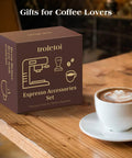 Box of espresso accessories set on wooden table with cup of latte, labeled as gifts for coffee lovers.