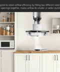 Front view of a white kitchen range hood with galvanized ducting and a black connector over a wooden counter.