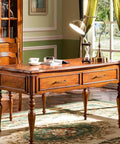 Antique brass cabinet handles on a vintage wooden desk with elegant legs in a classic room setting.