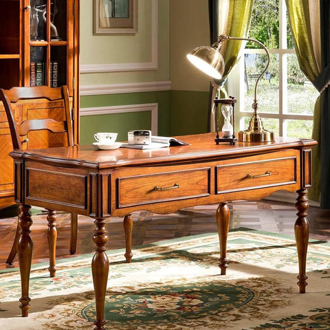 Antique brass cabinet handles on a vintage wooden desk with elegant legs in a classic room setting.