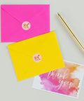 Slick Round Printable Labels 1 2/3 Inch Matte White 600 Count on pink and yellow envelopes with a thank you card.