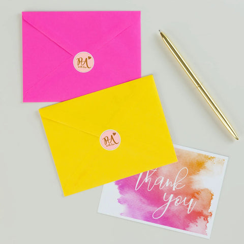 Slick Round Printable Labels 1 2/3 Inch Matte White 600 Count on pink and yellow envelopes with a thank you card.