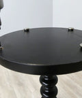 Installing Beat The Wobble Instantly 1 1/4 Inch Round Floor Protectors with a drill on a black table surface.
