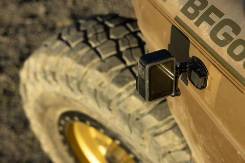 Premium Flat And Curved Surface Action Camera Mounts Featuring Industrial Strength Adhesive that sticks to a vehicle tire.