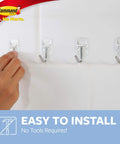 Person installing Damage Free Hanging Wall Hooks For Small Decor Clear Wire Toggle Hooks With Adhesive Strips No Tools Needed