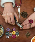 Person using pliers from Jump Ring Jewelry Making Kit With 1200 Silver And Gold Rings Pliers Tweezers Opener And Brass Ring Tools.
