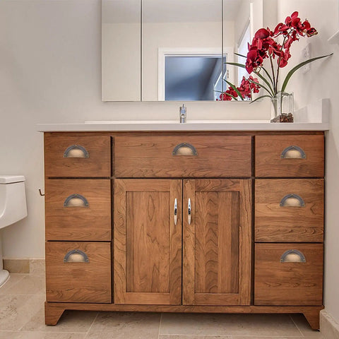 Antique Brass Cabinet Handle Set 2 Pack Shell Drawer Pulls on wooden bathroom vanity for classic style and solid grip.