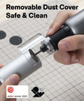 Side view of HOTO 4V cordless rotary tool with LED light and clear guard, held over a grid cutting mat