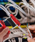 Single Handed Cable Threading Tool For Electricians With Plastic Steel Construction Time Saving Wire And Cable Puller For Junction Boxes And Office Installations Neat Pro Grade Cable Layout During Home Renovations And Upgrades. Red tool with wire in hand
