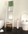 Bathroom with Heavy Weighted Free Standing Toilet Paper Holder With Reserve Function Matte Black Finish beside toilet.