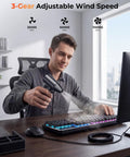 Man using Powerful High Speed 110000 RPM Electric Air Duster With Brushless Motor 3 Speed Settings to clean computer keyboard