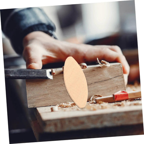 Close-up of 100 Piece Real Deal Hardwood Joiner Biscuit being inserted into wood for woodworking jointing.