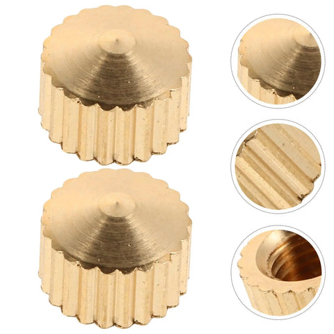 Golden metal nuts from 20 Piece Clock Nut Set For Repair And DIY Projects, showing close-up details and ridges.