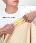 Close-up of person demonstrating tear resistance of Waterproof Outdoor 3-Seater Sofa Cover Heavy Duty Protects Your Patio Furniture Up To 79W X 38D X 35H Inches With Durable Fabric All Weather Shield Easy Fit And Adjustable Straps For A Snug No Fuss Look