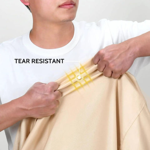Close-up of person demonstrating tear resistance of Waterproof Outdoor 3-Seater Sofa Cover Heavy Duty Protects Your Patio Furniture Up To 79W X 38D X 35H Inches With Durable Fabric All Weather Shield Easy Fit And Adjustable Straps For A Snug No Fuss Look