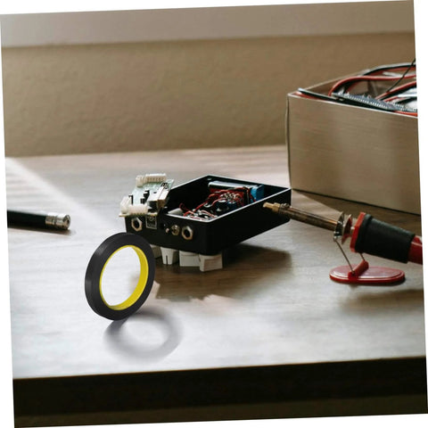 One Roll Blackout Tape For Windows That Blocks LED Light And Dims Screens With Heavy Duty Adhesive Window Covering shown on a desk.