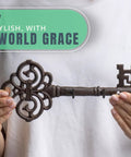 Brown Cast Iron Skeleton Key Wall Hook With Three Heavy Duty Coat Holders For Classic Farmhouse Vibes And Simple Down Home Entryway Organization Built Rock Solid For Everyday Hanging held in hands.